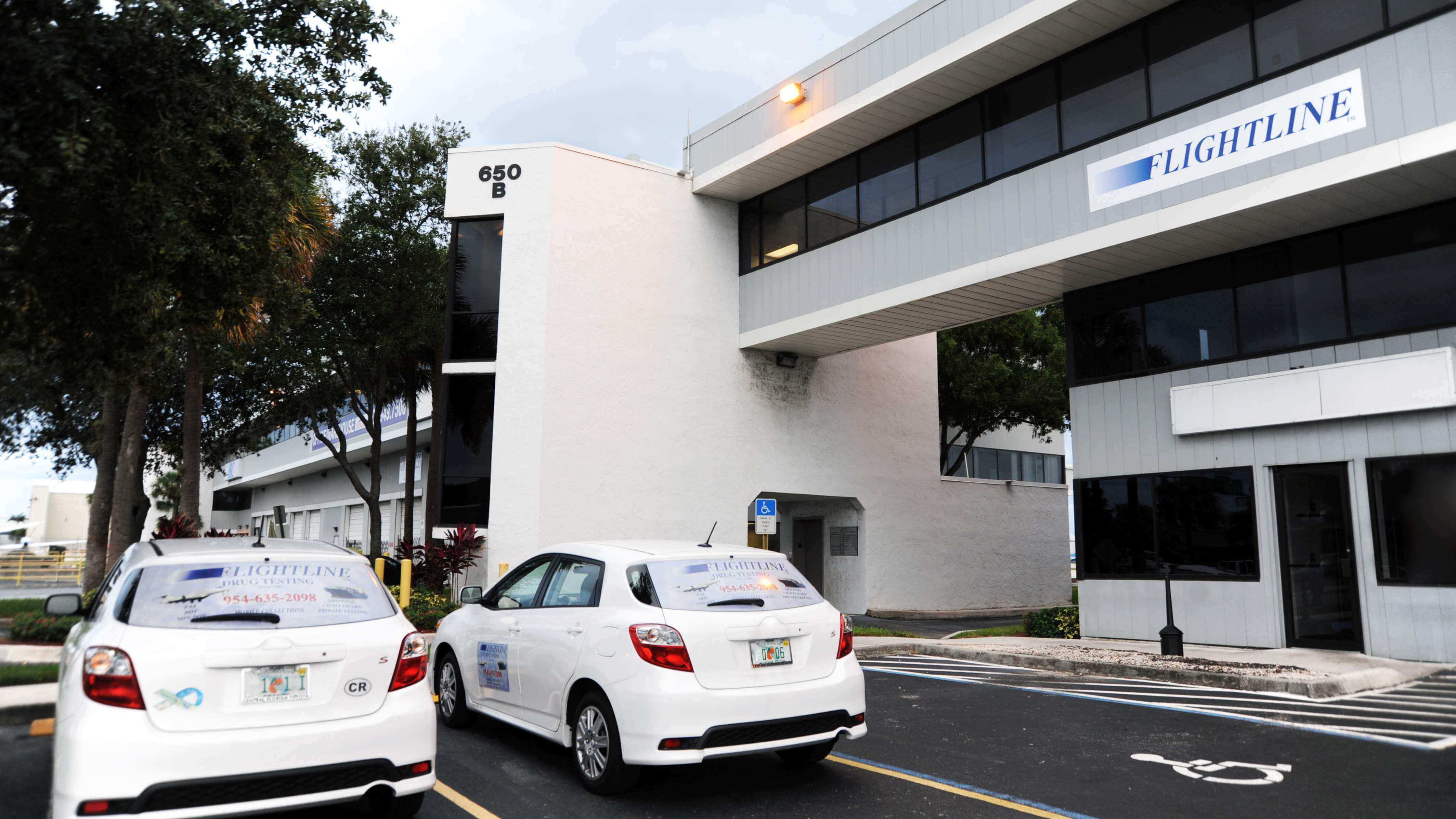 Lightline building with parked cars outside.